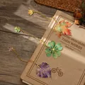 Set of 3 artistic leaf metal bookmarks with colorful enamel-like design and gold chain. - Set of 3 / Maple And Clover And Perilla