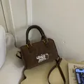 Retro brown leopard print suede Boston bag featuring an embroidered patch and gold hardware - Coffee