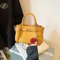 Chic yellow frosted suede handbag with retro buckle and pom-pom charm detail sku - With Pendant / Yellow