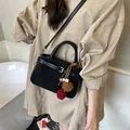 Vintage black frosted crossbody bag with decorative plush ball charms and top handle - With Pendant / Black