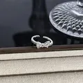 Eleganter verstellbarer silberner Schleifenring mit funkelnden Kristallen auf Display. - Wassertropfen-Zirkonia-Schleifenstil(6) / Silber