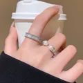 Detailed view of silver-tone open ring with double pearls and stacked eternity band. - Twist Pearl Open Ring (J1090) / Pearl White