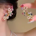 Detailed close-up of vibrant dopamine style flower ear cuff with colorful stones - Flower (E7020)