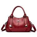 Elegant red grained leather handbag with top handle and kangaroo logo metal details. - Red