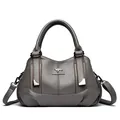 Elegant grey pebble leather handbag with top handles and adjustable shoulder strap - Gray