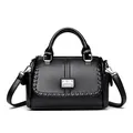 Elegant black textured leather handbag with top handle and adjustable shoulder strap - Black