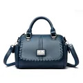 Elegant blue textured leather handbag with decorative braided trim and top handle - Blue
