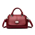 Elegant dark red faux leather handbag with unique braided trim and sturdy top handle - Red