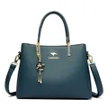 Elegant teal leather handbag with gold-tone hardware and kangaroo logo charm - Blue