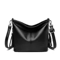 Elegant black pebble leather bucket bag with tassels and adjustable strap - Black