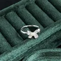 Detailed macro view of a vintage silver pearl bow ring set against green velvet - No.2 Open Ring (Rhinestone Bowknot Style)