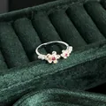 Macro detail of a vintage silver-tone open ring featuring pearls and red flower stones - No.5 Open Ring (Double Floral Red Gemstone Style)