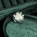 Detail showing a retro silver ring with a pearl center and sparkling starburst motif. - No.6 Open Ring (Starburst Pearl Cluster Style)