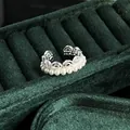 Detailed close-up of a vintage French style lace pearl ring on a dark green velvet display - No.7 Open Ring (Lace Hollow Pearl Band Style)