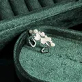 Detail view of a vintage French style pearl bow ring on dark green velvet - No.8 Open Ring (Heart Shell Bowknot Pearl Style)