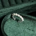 Macro detail of French vintage silver lace ring with white pearls on green velvet - No.9 Open Ring (Lace Texture Half Arc Pearl Style)