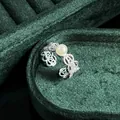 Exquisite close-up of a vintage lace silver ring with a pearl on green velvet - No.10 Open Ring (Main Pearl Lace Bowknot Style)
