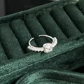 Elegant French vintage pearl ring with sparkling central stone on green velvet background - No.11 Open Ring (Center Rhinestone Pearl Accent Style)