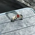 Macro detail of a silver ring with a pomegranate red gemstone in a blue velvet box - Oval Geometric Faceted Style (18号) / Adjustable Open / Garnet Red