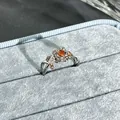 Exquisite detail of a silver floral ring featuring a vibrant garnet-red center stone. - Silver Leaf Floral Style (No. 25) / Garnet Red