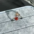 Detailed macro view of the flower and garnet red heart stone on an adjustable open ring - Heart Zirconia Flower Style (No. 26) / Garnet Red