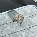 Macro detail of an elegant silver flower ring featuring pomegranate red gemstones - Vintage Layered Flower (No. 30) / Garnet Red