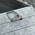 Detailed close-up of a silver flower ring with a garnet red oval center stone - No. 32 Open Ring