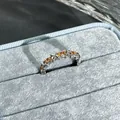 Elegant silver open ring with pomegranate red stones displayed in a blue velvet box - Style 1 Adjustable Ring