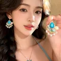 Detail of forest style floral earrings with turquoise drop and pearl fringe - Blue (E6929)