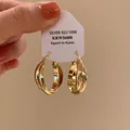 Macro detail of gold multi-layer hoop earrings presented on a silver 925 display card. - Hoop Buckle Style / Twisted Ribbon Hoop Earrings - A2791 Gold / Gold