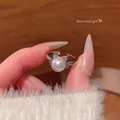 Adjustable silver ring featuring a large white pearl and a dainty crystal bow - Single Pearl Bow (J1068) / Adjustable Open / Silver