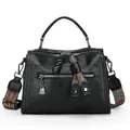 Stylish black Boston handbag for women with a colorful patterned textile shoulder strap. - Black