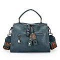 Stylish teal Boston handbag with vintage leather texture and colorful patterned strap - Blue