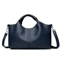Elegant dark blue pebbled leather handbag with kangaroo logo and crossbody strap - Blue