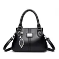 Elegant black textured leather handbag for women with silver leaf charm and top handle - Black