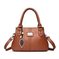 Elegant brown leather handbag for women featuring a stylish kangaroo logo and leaf charm - Yellow