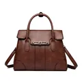 Elegant brown faux leather handbag featuring a kangaroo logo and adjustable crossbody strap - Brown