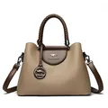 Elegant khaki pebble leather handbag with kangaroo logo and woven handle decoration. - Woven Handle Tote Bag / Light Khaki