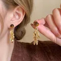 Close-up of Maillard style acrylic resin dangle earrings with gold leaf tassel details - Round Ball Metal Leaf Tassel (A2031) / Gold