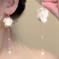 Close-up detail of elegant French style petal and pearl dangling earrings on a model - Multi-Layer Petal Pearl Tassel Long Style (E1259 Gold)