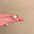 French style baroque pearl adjustable ring with bow design shown on hand - J1068 Bow Pearl Style (J1068) / Adjustable Open / Silver