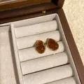 Elegant Maillard style amber acrylic resin stud earrings with irregular gold trim detail - Irregular Gold Frame Amber Resin Studs (A2755)