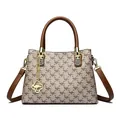 Elegant designer kangaroo print handbag with brown top handles and gold hardware charm - Lattice & Khaki