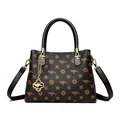 Elegant brown printed handbag featuring kangaroo motifs and golden clover pendant - Petal Pattern & Brown