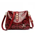 Retro red embossed floral shoulder bag with glossy finish and gold-tone hardware for women - Red