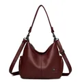 Elegant burgundy leather hobo bag with adjustable strap and kangaroo logo detail. - Red