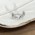 Detailed close-up of a silver wing-shaped open ring with sparkling cubic zirconia - No. 3 Pave Wing Open Ring