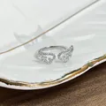 Detail of a minimalist silver-colored ring featuring elegant stone-encrusted wing motifs - No. 4 Minimalist Wing Open Ring