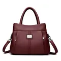 Elegant maroon textured leather handbag with top handle and adjustable crossbody strap for women - Burgundy