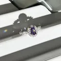 Detail view of an oval purple gemstone ring with sparkling diamond halo in silver finish. - Oval Full Diamond Purple Style
